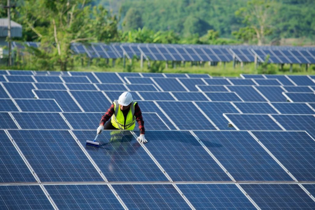 cleaning-solar-panels-by-workers-in-uniform-safety