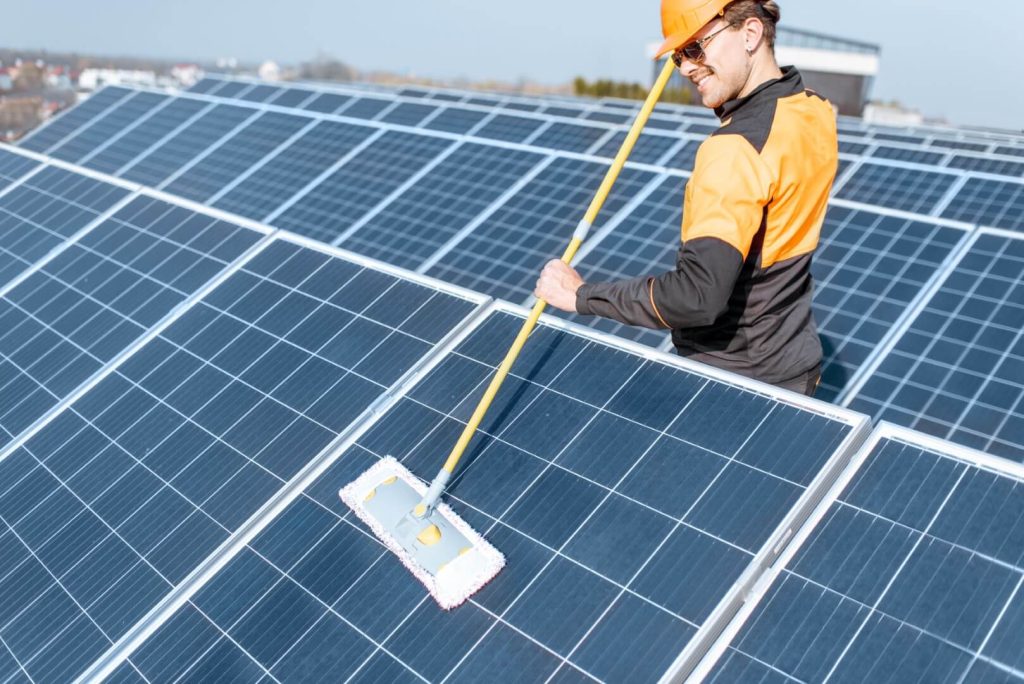 workman-cleaning-solar-panels